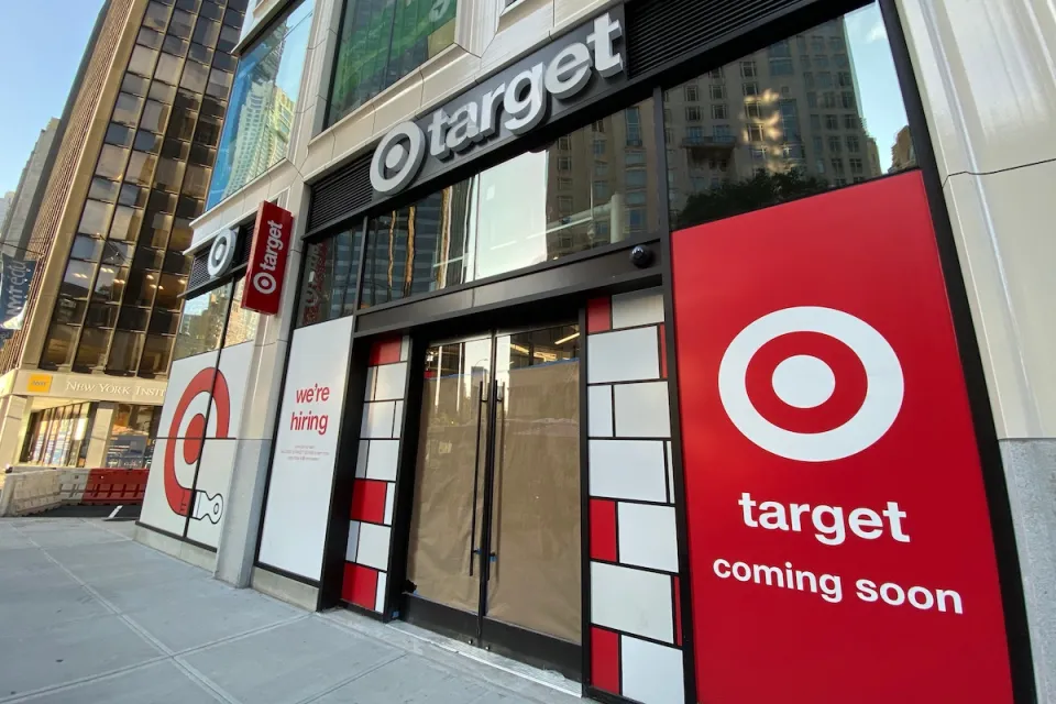 Storefront of small Target in New York City with "coming soon" and "now hiring" signs in window.